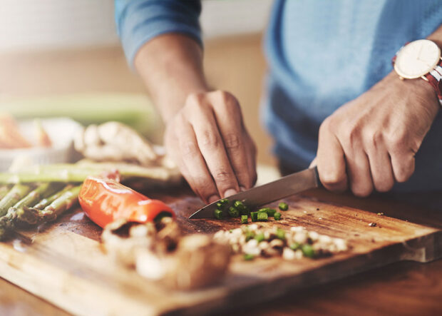 man chopping veg moneyplus man chopping hot tips to cut the cost of cooking