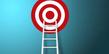 new year goal feature red and white target on blue background, with white ladder reaching up to the target
