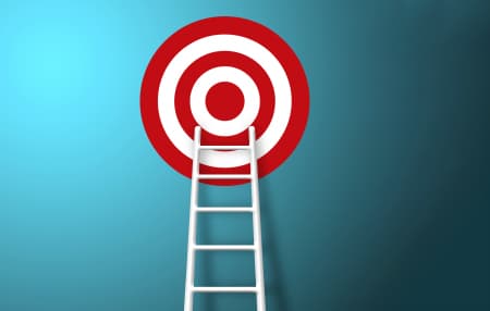 red and white target on blue background, with white ladder reaching up to the target