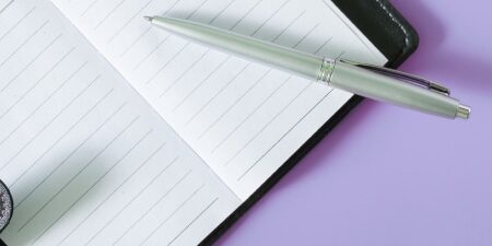 Diary-Feature open notebook against light purple background