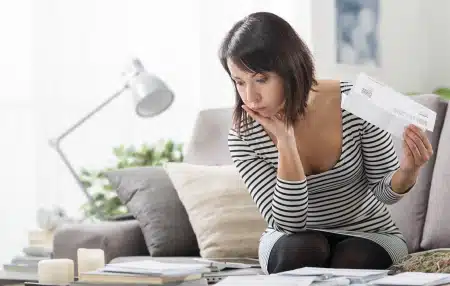 Woman looking at her paper bills