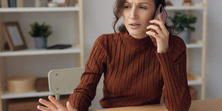 What-is-debt-collection-feature Woman on the phone looking confused