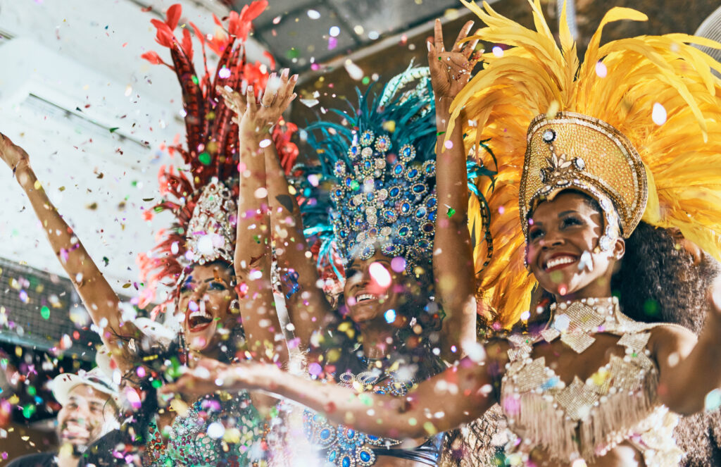 Cropped shot of beautiful samba dancers performing in a carnival with their band