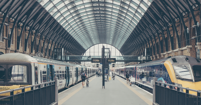 Image of 2 trains on the platform at Kings Cross Station in London.