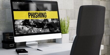Debt-Management-Phishing_-How-to-Avoid-Being-Scammed-feature An image of an imac with the word "phishing" on the screen