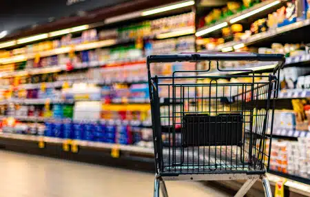 Image of a shopping trolley in an aisle at a supermarket 