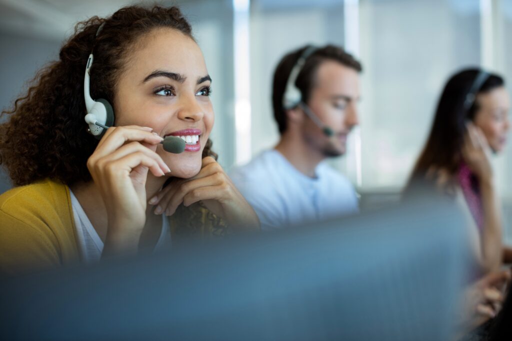 Woman speaking on the phone to a customer who works at a call centre 