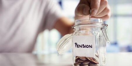 How Much Should I Pay Into My Pension_ feature Image of a mason jar with the label "pension" on it with some coins inside.