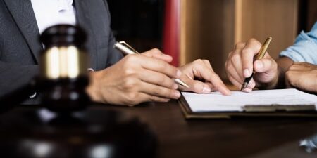 What happens if you don’t have a will_ feature Image of two people signing a piece of paper