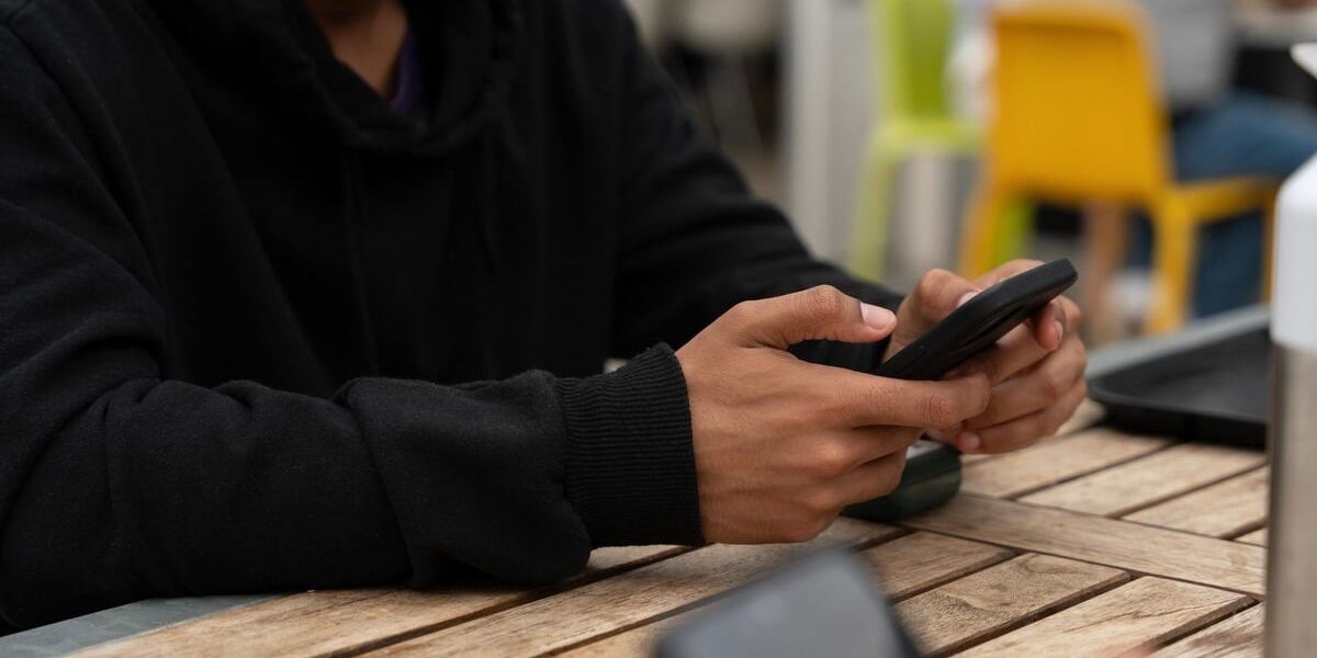 AdobeStock_1534629408-min (1) scrolling on phone for money help