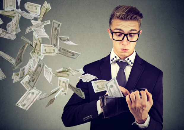 Man throwing money out of his wallet